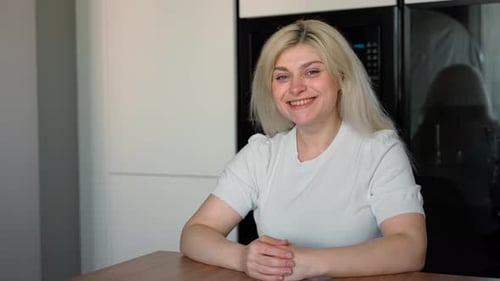 Young Blond Woman Smiling at the Camera