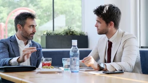 Businessmen during meeting in cafe