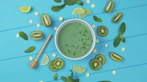 Sweet Dessert with Spirulina on a Blue Wooden Background