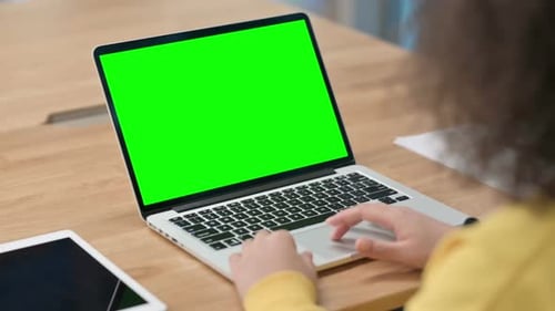 African Businesswoman Using Laptop with Green Chroma Key Screen