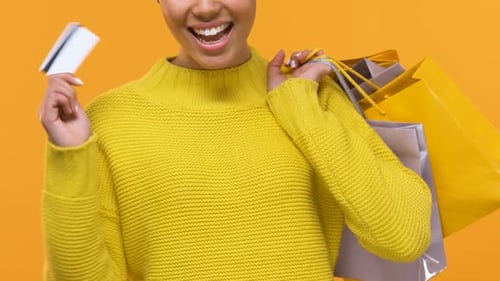 Stylish Young Female With Purchase Bags Showing Credit Card, Shopping Cash Back
