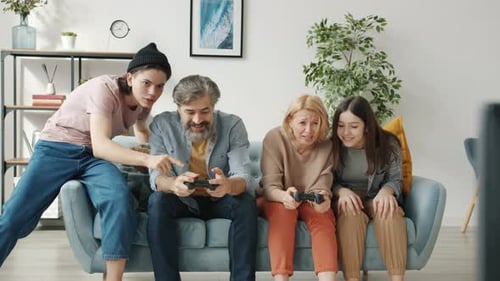 Family Enjoys Playing Video Games Together at Home