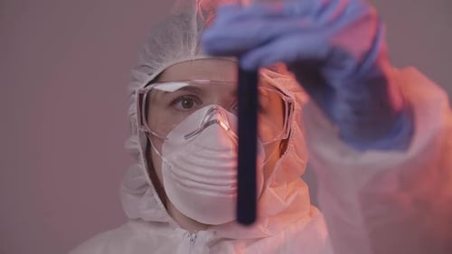 Protected Scientist Pouring Liquid in a Laboratory. Research and Science Concept