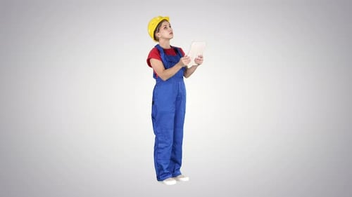 Woman in Hardhat Using Tablet