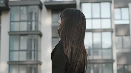 Woman With Long Hair Turns Toward the Camera