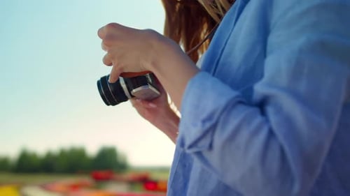 Closeup Woman Hands Holding Professional Photo Camera in Blooming Garden Outdoor