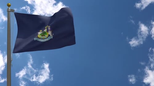 Maine State Flag Waving Against Blue Sky and Clouds