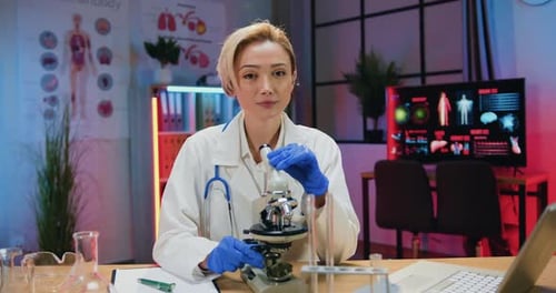 Woman Using Microscope in Modern Lab