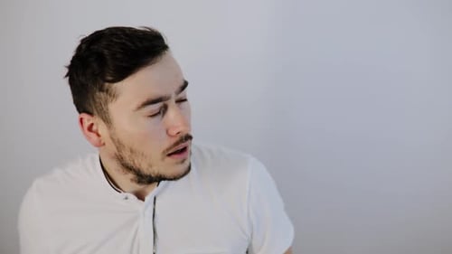 Shocked Young Man Reacting to Something Off-Screen