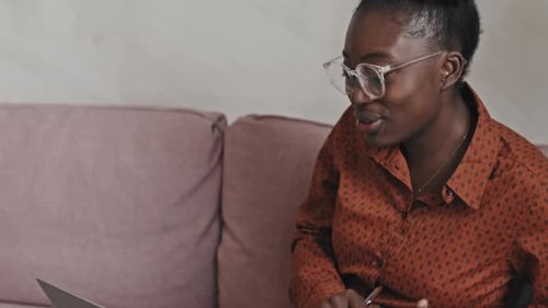 Woman Video Conferencing on Laptop at Home