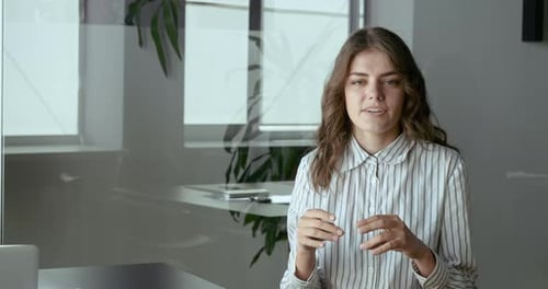 Woman Explaining a Concept in a Modern Office