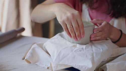 Woman is Making Ceramic Cup Forming Clay in Workshop Closeup of Hands