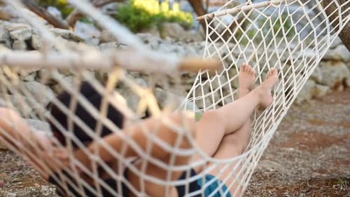 Woman Relaxing in Hammock in Nature