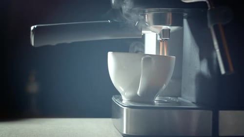 Pouring Coffee Stream From Machine in Cup