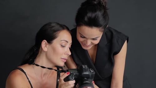 Women Reviewing Photos on DSLR Camera in Studio