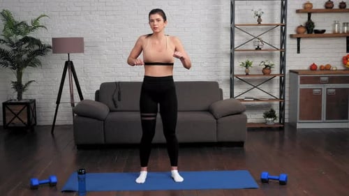 Woman Stretching Arms in Home Gym