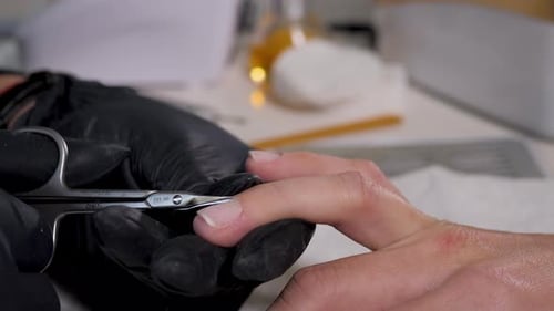Close Up Macro Finger Nail Care By Manicure Specialist in Beauty Salon. Manicurist Clear Cuticle