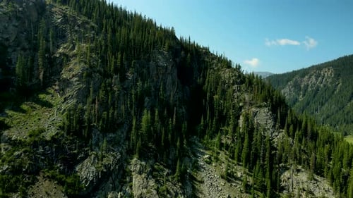Flying towards the rugged cliffs and granite peaks in the Rocky Mountains