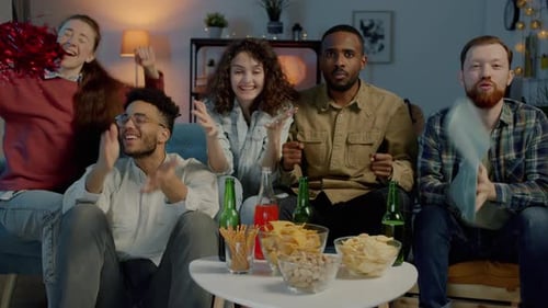 Friends Celebrate While Watching Sports Game Together