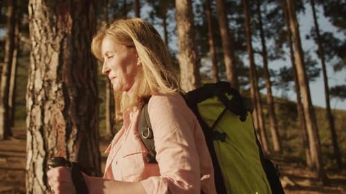 Active senior woman hiking in forest