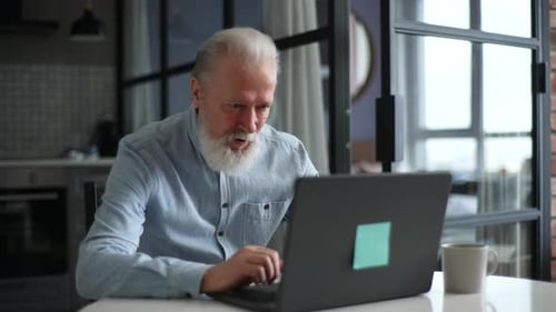 Smiling Senior Man Using Laptop for Video Call