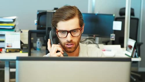 Man Talking on Phone in Modern Office