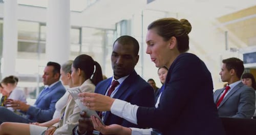 Business People Discussing Information on a Tablet
