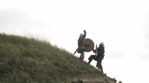 Medieval Warriors Fighting on Grassy Hillside