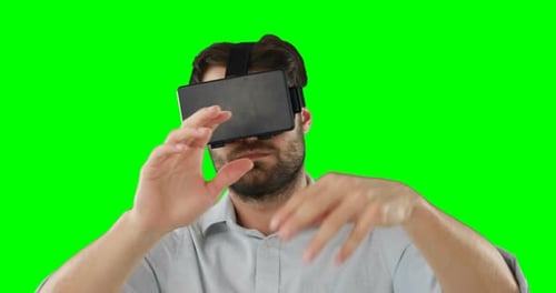 Man Wearing VR Headset Gesturing on Green Screen