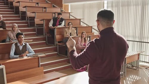 Male University Professor Talking to Students during Seminar