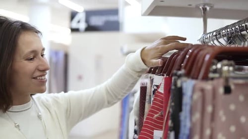Woman Browsing Fabric Samples in a Store