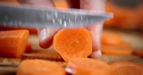 Slicing a Fresh Carrot on Cutting Board