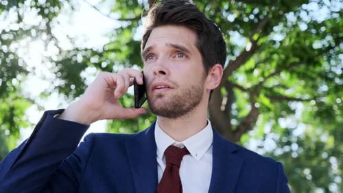 Businessman using smartphone in park