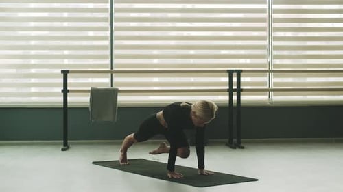 Woman Doing Yoga Poses in Bright Studio
