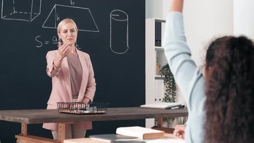 Schoolgirl Answering Question in Math Class