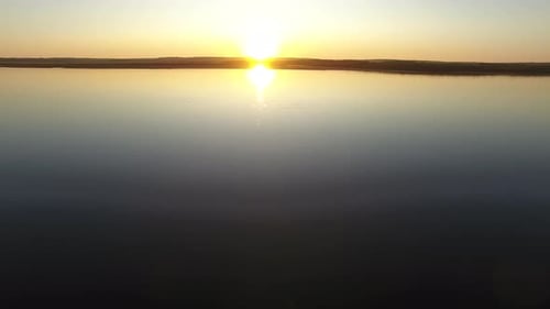Flying Over Water Towards Sun