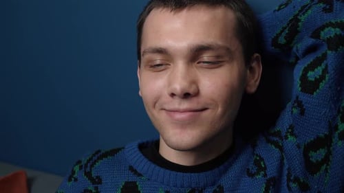 Young Adult Reclining in Blue Sweater