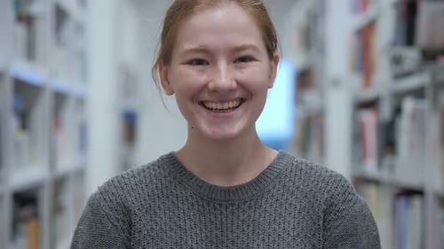 Portrait of Smiling Young Woman Looking at Camera in Cafe