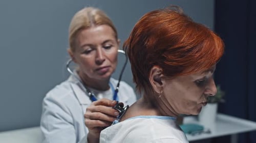 Doctor Examines Patient with Stethoscope in Clinic