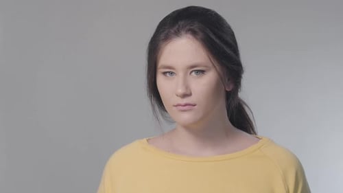 Close-up Face of Displeased Caucasian Woman Turning To Camera and Looking with Disdain Expression