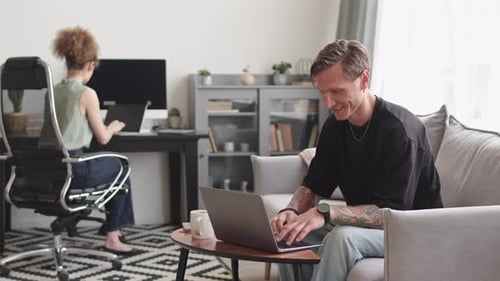 Couple of IT Specialists Working from Home