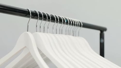 Wooden Clothes Hangers on Black Metal Rack