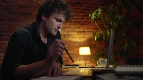 Young Successful Businessman Thinking Working in Office at Night