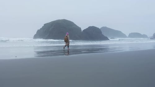 Aerial Woman Walking By Wet Beach Surface with Beautiful Silhouette Reflection