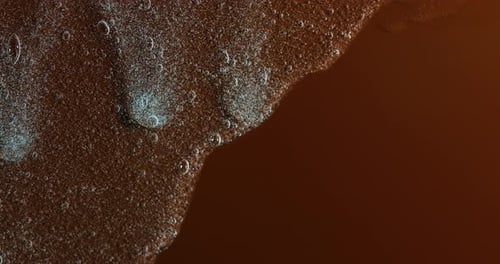 Amber Liquid with Many Bubbles Dripping Slowly