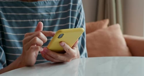 Person Using Touchscreen Phone Indoors Close Up