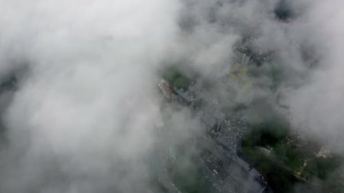 Aerial view look down low foggy cloud over apartment