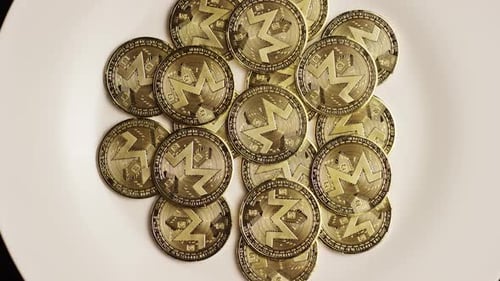 Pile of Monero Cryptocurrency Coins on White Surface