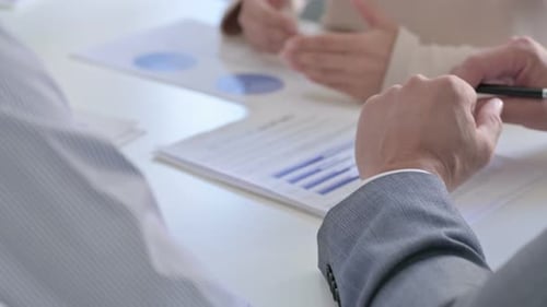 Close up of Hands of Business People Reading Documents, Writing on Paper