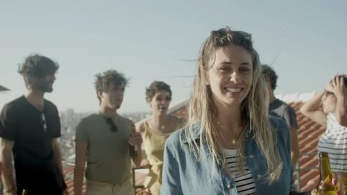 Friends Enjoying Rooftop Gathering on Sunny Day